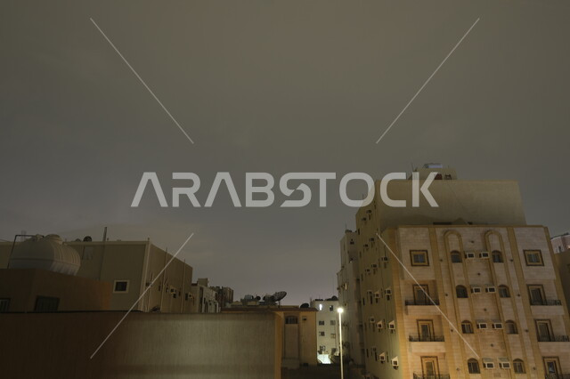 Lightning and thunder over residential buildings in Al-Safa district in the sky of Jeddah city at night, winter weather in the Kingdom of Saudi Arabia, weather conditions, disasters and natural phenomena, nature background