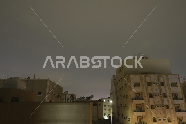 Lightning and thunder over residential buildings in Al-Safa district in the sky of Jeddah city at night, winter weather in the Kingdom of Saudi Arabia, weather conditions, disasters and natural phenomena, nature background
