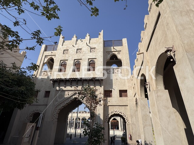Ancient historical landmarks, old-style architectural designs, entrance to Al-Qaisariya Market in Al-Ahsa city during the day, traditional archaeological popular markets, famous heritage tourist places in the Kingdom of Saudi Arabia, tourist attractions and attractions