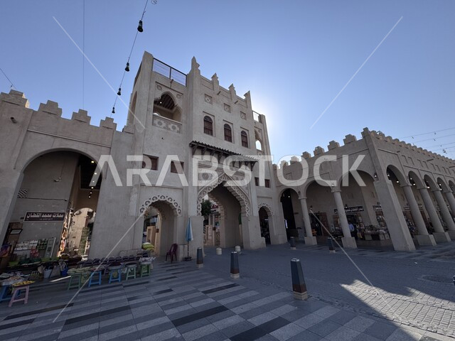 Ancient historical landmarks, old-style architectural designs, entrance to Al-Qaisariya Market in Al-Ahsa city during the day, traditional archaeological popular markets, famous heritage tourist places in the Kingdom of Saudi Arabia, tourist attractions and attractions
