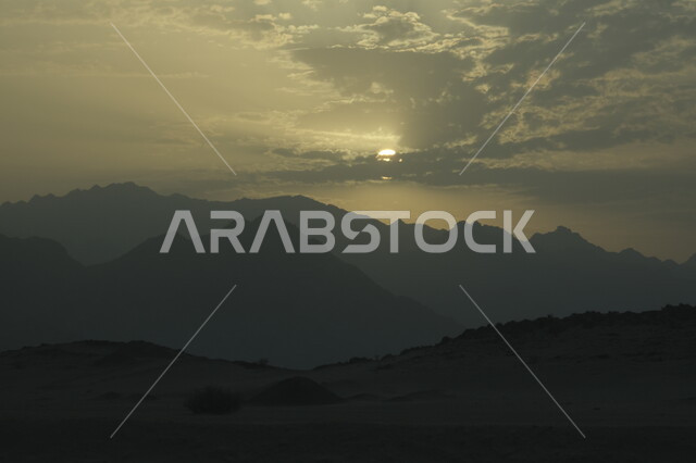 Landscape in Wadi Asfan at sunset, Dry and harsh environment and nature, Sand formations and formations and dunes, Soft golden sand in the deserts of Saudi Arabia, Terrain and hills in desert areas