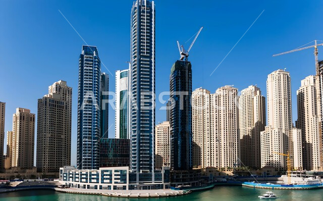 Modern architecture of Intercontinental Hotel in Dubai Marina, urban growth and development of towers and skyscrapers overlooking the sea, famous places and tourist attractions in the United Arab Emirates