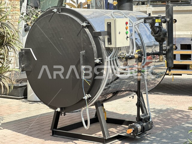 Reliance on modern and advanced technologies in the Kingdom of Saudi Arabia, a close-up image of an electric steam boiler, the use of disinfection machines and equipment that depend on the evaporation process in their work, steel tanks and heaters in factories, hospitals and laundries in the city of Riyadh