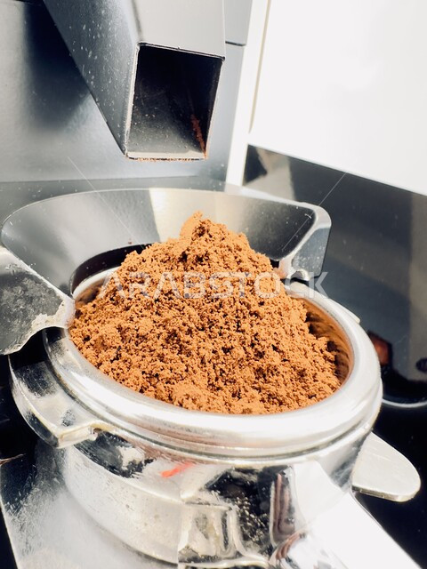 Riyadh, Saudi Arabia : Oct  19, 2024 - Title: porta filter with coffee powder after being ground with a automatic grinder machine.