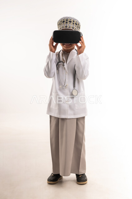 Integration and simulation of the virtual world, technical and technological development in the field of medicine, portrait of an Arab Gulf Omani boy wearing a mask and a white coat, wearing a stethoscope and looking through 3D glasses, choosing a future profession since childhood, full body length, white background