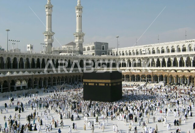 Performing Hajj and Umrah rituals, pilgrims circumambulating the Kaaba in Mecca, the concept of worship and drawing closer to God, sacred Islamic religious places and landmarks in the Kingdom of Saudi Arabia