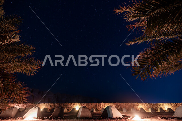 Wild camping trip, desert environment of camping sites in the Kingdom of Saudi Arabia, youth desert outing, traditional lighted tent in the desert, enjoying the quiet atmosphere at night