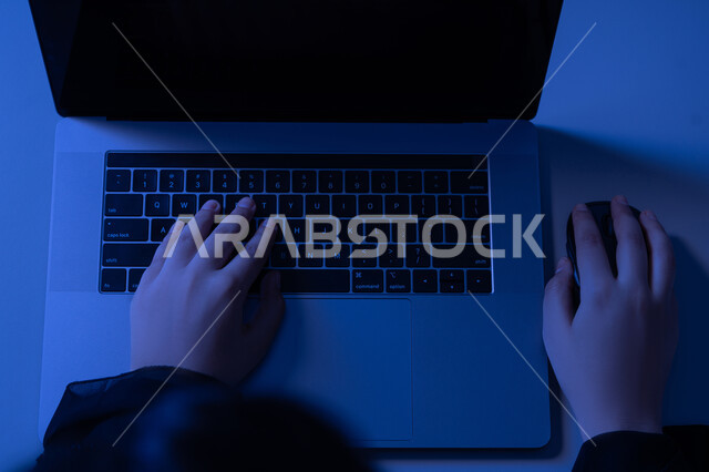 النقر على لوحة المفاتيح، مهن ووظائف إدارية مكتبية، دمج التكنولوجيا الحديثة بالحياة العملية، مفهوم ادخال البيانات، صناعة المحتويات النصية، صورة علوية عامودية لايدي امرأة عربية خليجية اماراتية تستخدم الحاسوب المحمول، شابة سعودية تقوم بالكتابة على جهازاللابتوب