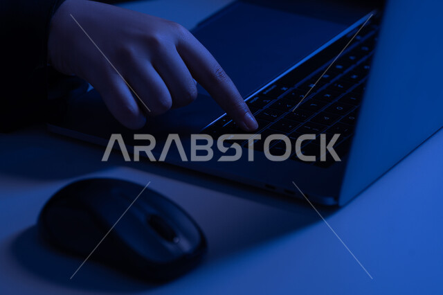 Clicking on the keyboard, office administrative jobs and professions, integrating modern technology into practical life, data entry concept, text content creation, close-up of the hand of an Arab Gulf Emirati woman using a laptop, a young Saudi woman typing on a laptop