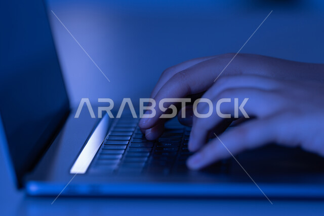 Office administrative jobs and professions, integrating modern technology into practical life, clicking on the keyboard, data entry concept, creating text content, close-up of the hands of an Arab Gulf Emirati woman using a laptop, a young Saudi woman typing on a laptop