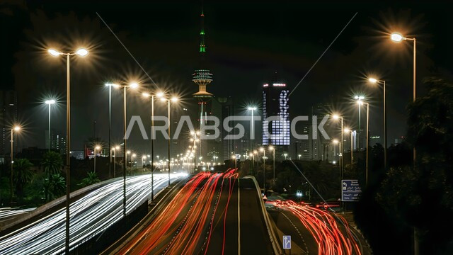 Liberation Tower in Kuwait at night, architectural art of building towers and skyscrapers, famous tourist places, attracting and attracting tourists from all over the world, lighting poles on both sides of the car route