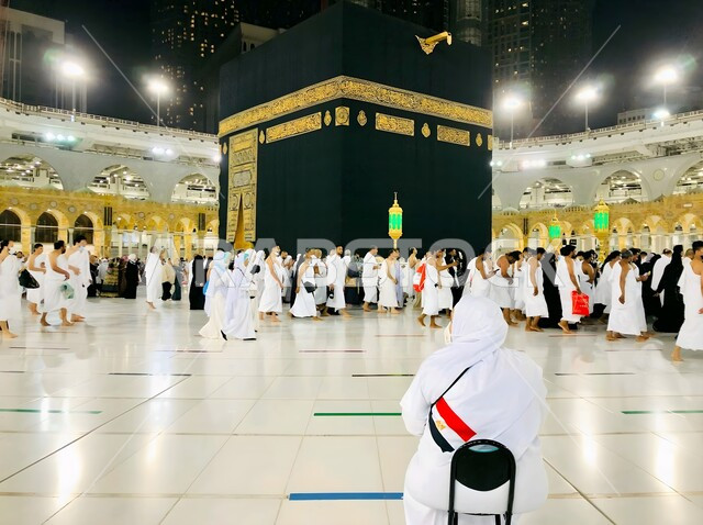 Sacred Islamic religious places and landmarks, pilgrims circumambulating the Sacred House of God in the courtyards of the Holy Mosque in Mecca, a close-up of the Holy Kaaba in Mecca in the Kingdom of Saudi Arabia, performing the Hajj and Umrah rituals