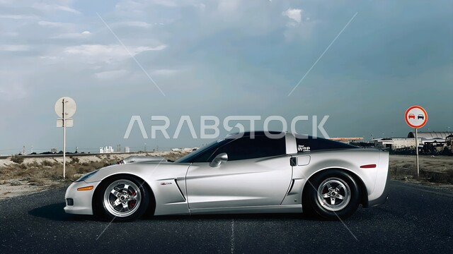 Famous brands, modern land transportation, distinguished car showroom in the State of Kuwait, luxury sports vehicle, elegant vehicle events and exhibitions, luxurious gray Chevrolet Corvette parked on a street