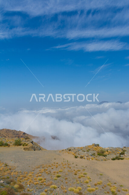 Famous landmarks and tourist places, mountainous nature in the Kingdom of Saudi Arabia, rock formations and formations, heights and peaks, view of the sky filled with clouds above the mountains in the city of Taif