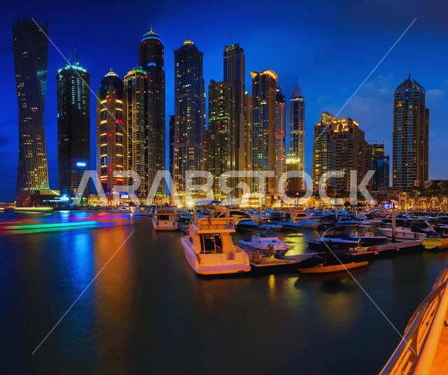 High-rise buildings and structures overlooking the sea, famous coastal tourist places and landmarks in the United Arab Emirates, attracting and attracting tourists from all over the world, urban development and progress, the architectural art of building towers and skyscrapers illuminated at night