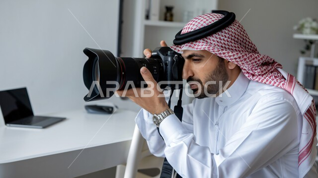 Using high-resolution digital cameras, practicing photography hobby, advanced equipment and techniques, a smiling young Saudi Arabian Gulf man wearing traditional thobe and shemagh holding a high-resolution camera in his hand, gestures of admiration and happiness with the profession