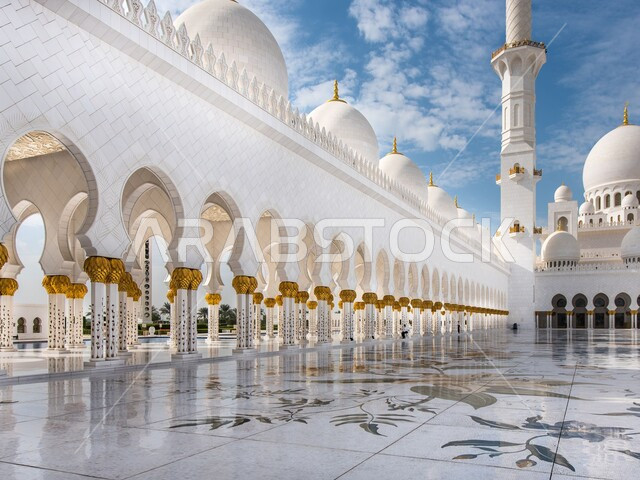 The outer courtyard of Sheikh Zayed bin Sultan Al Nahyan Mosque in the Emirate of Abu Dhabi, the concept of worship and drawing closer to God Almighty, the architecture of mosques in the United Arab Emirates, Islamic landmarks and sacred places during the day, the call of Muslims to perform worship and duties