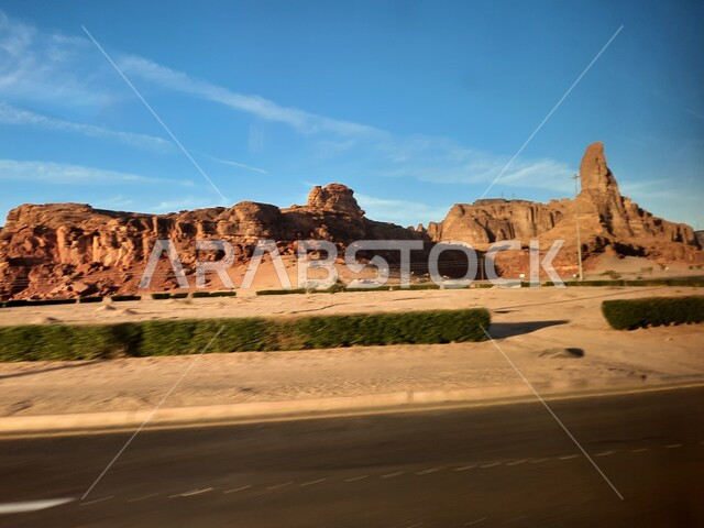 Paved asphalt roads and streets in the desert, rock formations and formations in AlUla in the middle of the deserts of the Kingdom of Saudi Arabia, ancient historical landmarks in Madain Saleh, tourist places in desert areas