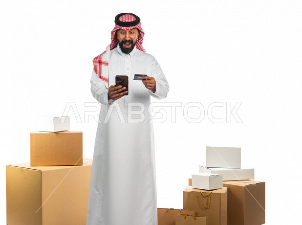 Portrait of a Saudi Arabian Gulf man working in the delivery of orders and goods to customers, online shopping, online orders, store keeper, the ability to pay by credit card, purchase and payment through mobile phone programs and applications, facial ges