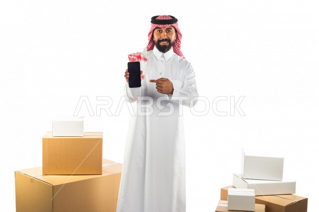 Portrait of a Saudi Arabian Gulf man working in the delivery of orders and goods to customers, online shopping, online orders, store keeper, order documentation, purchase and delivery through mobile applications