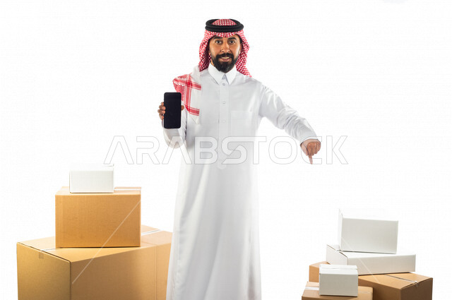 Portrait of a Saudi Arabian Gulf man working in the delivery of orders and goods to customers, online shopping, online orders, store keeper, order documentation, purchase and delivery through mobile applications