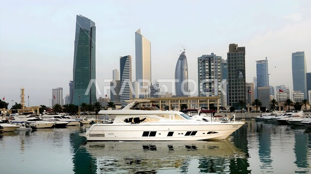 Architectural engineering art of building towers and skyscrapers in modern style, buildings and facilities overlooking the sea, famous coastal tourist places in Kuwait, boats for tours and recreational cruises
