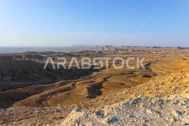 The Tuwaiq mountain range in Najd at sunset, desert nature and mountainous terrain in Saudi Arabia, famous natural tourist attractions, the rocky edge of the apocalypse in the Riyadh desert in the Kingdom of Saudi Arabia