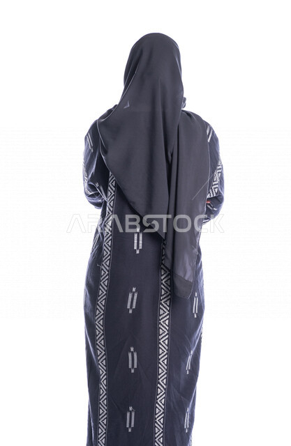 Portrait of a Saudi Arabian Gulf woman, doing a photo session with different facial and hand gestures, a view from the back of a veiled Saudi Muslim young woman wearing a Gulf abaya, white background