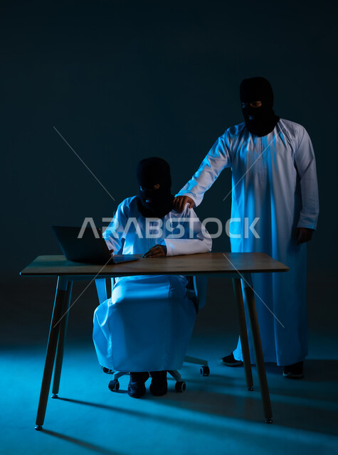 Algorithms to destroy digital accounts, use of computer for illegal purposes, cyber security intrusion, data hacking and theft, portrait of two masked Gulf Arab Omani hackers wearing dishdashas working in the field of hacking, blue background