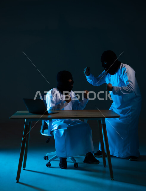 Successful data hacking and theft, algorithms to destroy digital accounts, use of computer for illegal purposes, cyber security intrusion, portrait of two masked Gulf Arab Omani hackers wearing dishdashas raising their fists with expressions of joy, blue background
