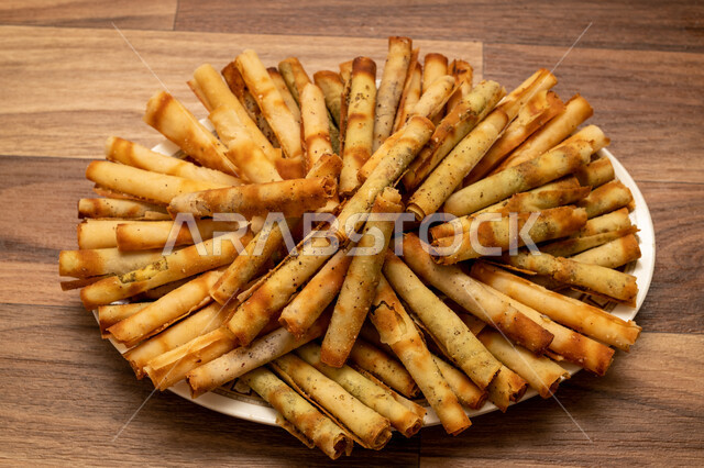 المقبلات العربية الشرقية الشهية, المأكولات الشهية الشعبية, الأساليب الفنية بتقديم الطعام في مطاعم ومطابخ المملكة العربية السعودية, طبق من الخبز المقرمش على طاولة خشبية قديمة