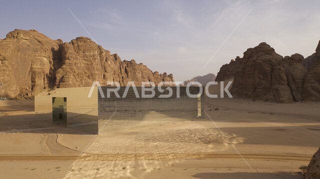 Famous landmarks, the largest reflective building in the world, the glass Maraya Theater in Al-Ula Governorate in the Kingdom of Saudi Arabia, rock formations and mountainous terrain in desert areas, architectural art