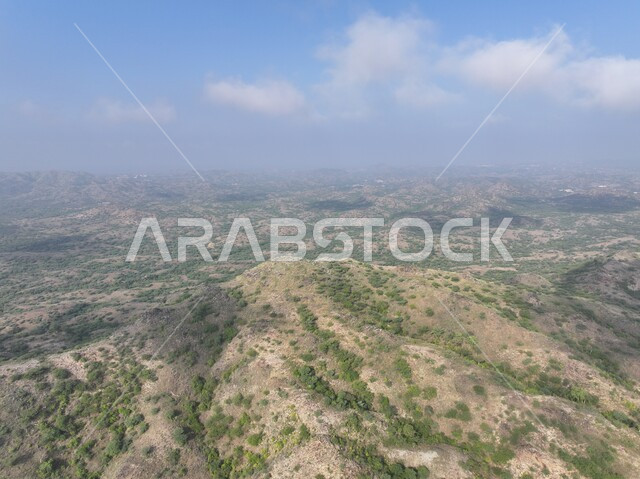 Foggy weather in Fifa region, highlands and mountain ranges, rock formations and formations in Jazan city, green plants planted on mountains, distinctive natural landscapes, famous tourist places and landmarks in the Kingdom of Saudi Arabia