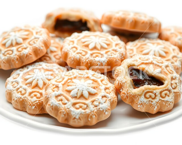 Fresh popular sweets, hospitality and good reception in Saudi Arabia, how to prepare and make delicious sweets, pieces of Eid sweets with nuts, delicious date cookies, celebrating happy Islamic holidays and occasions, local national product, white background