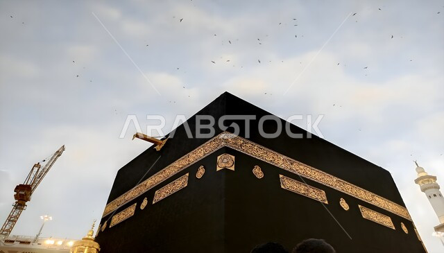 The Grand Mosque in the Kingdom of Saudi Arabia, a close-up image from below of the Kaaba in Mecca, performing Hajj and Umrah rituals, worship and drawing closer to God, a sacred Islamic religious landmark, the Qiblah of Islam and Muslims