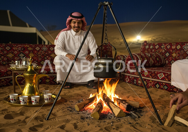Fun camping trip in the middle of the desert, calm night atmosphere, a Saudi Arabian Gulf man wearing traditional thobe and shemagh sitting in front of a firewood torch, a tourist camp in a desert area, a youth camp and desert session, formations and sand dunes, soft golden sand
