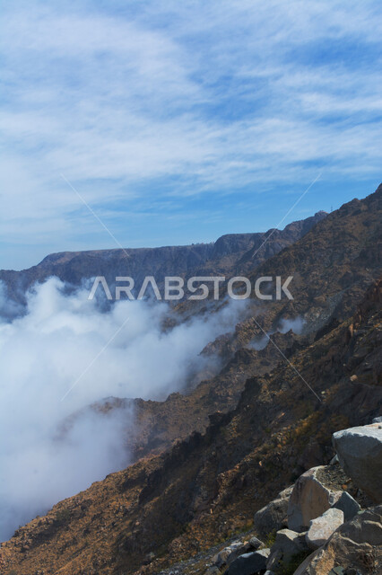 Rock formations and terrain in mountain peaks and heights, enjoying the natural scenery, Al Hada Mountains in Taif city in western Saudi Arabia, calm foggy winter atmosphere, famous tourist places