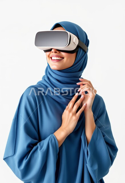 Using modern and advanced technologies, expressions of pleasure and happiness simulating the imaginary world, wearing virtual reality glasses, close-up portrait of a smiling Saudi Arabian Gulf woman wearing a hijab and a blue abaya, putting on 3D VR glasses, white background