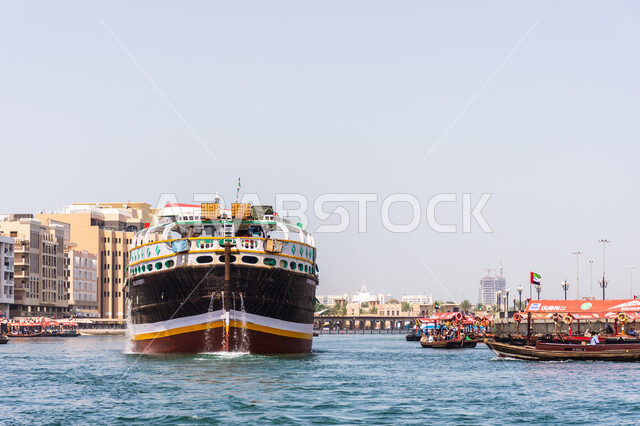 Large wooden ship for transporting goods and commodities, Economy and maritime trade in the United Arab Emirates, Port for transportation and shipping in the Bur Dubai area, Famous coastal tourist attractions, Maritime means of transportation