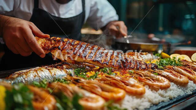 Delicious traditional grilled fish recipe, healthy and nutritious meal, delicious oriental Arabic food, the art of food presentation in restaurants and kitchens in the Kingdom of Saudi Arabia, close-up of a chef preparing a dish of shrimp garnished with parsley
