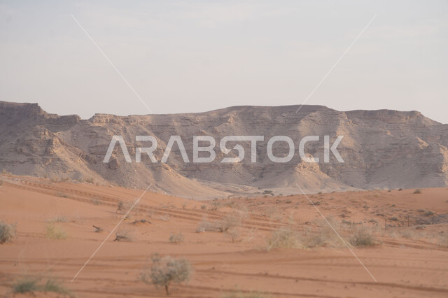 Sand formations and formations in the deserts of the Kingdom of Saudi Arabia, mountain peaks and heights in the desert areas, distinctive landscapes, soft golden sand in the desert of Riyadh city
