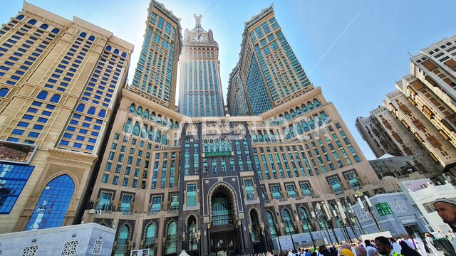 The growth and urban development of towers and skyscrapers surrounding the Grand Mosque, the Royal Clock Tower building in Mecca, sacred Islamic religious landmarks, modern architectural art in the Kingdom of Saudi Arabia