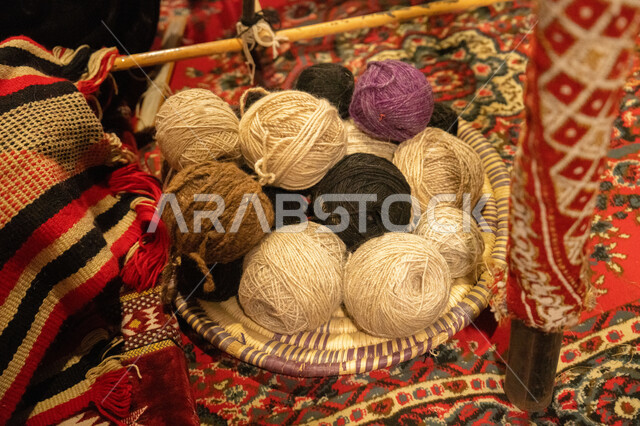 Traditional handicraft heritage art, the craft of making mashalehs in the Kingdom of Saudi Arabia, a popular traditional industry, spinning fabrics and cloth, a close-up of a group of colored threads