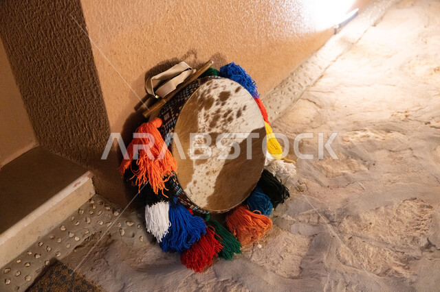 A musical instrument for folk songs and dances, traditional folklore shows, a hoop decorated with colored threads, the traditional drum for the popular Ardah, the concept of playing and singing, the authenticity of customs and traditions in the Kingdom of Saudi Arabia