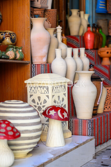A collection of traditional tools and artifacts made of porcelain and pottery in Souq Waqif in Doha, famous historical landmarks and tourist places in Qatar, old traditional popular markets