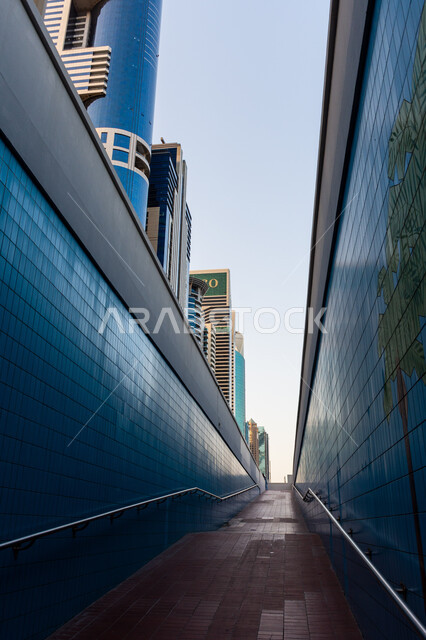 Growth, progress and urban expansion, architectural art of towers and skyscrapers, modern buildings and residential facilities in the United Arab Emirates, pedestrian walkway under Sheikh Zayed Road in Dubai, interest in infrastructure