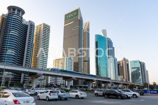 Providing parking spaces, urban development and infrastructure improvement, commercial buildings and facilities, the distinctive modern design of the Voco Hotel in Dubai during the day, the architectural art of towers and skyscrapers in the United Arab Emirates, attracting tourists from all over the world