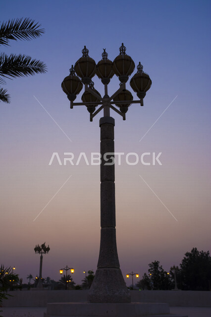 Lighting lamps in the streets of the Kingdom of Saudi Arabia, columns containing lanterns for street lighting at night, a picture at sunset in Saudi Arabia
