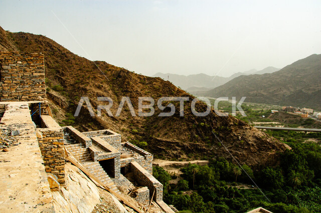 Famous historical landmarks in Saudi Arabia, ancient Arab architecture, rocky terrain, mountain peaks and heights, heritage stone buildings and houses, the ancient village of Dhi Ain in the city of Al Baha in the south of the Kingdom, natural places to attract and attract tourists
