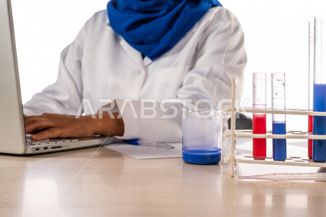 طبيبة مختبرات طبيه عربيه سعوديه خليجيه ترتدي معطف أبيض، إجراء التفاعلات الكيميائيه  داخل المختبر، تجارب و أبحاث طبيه، تسجيل النتائج و الملاحظات, دراسات وتحاليل, مواد كيميائيه